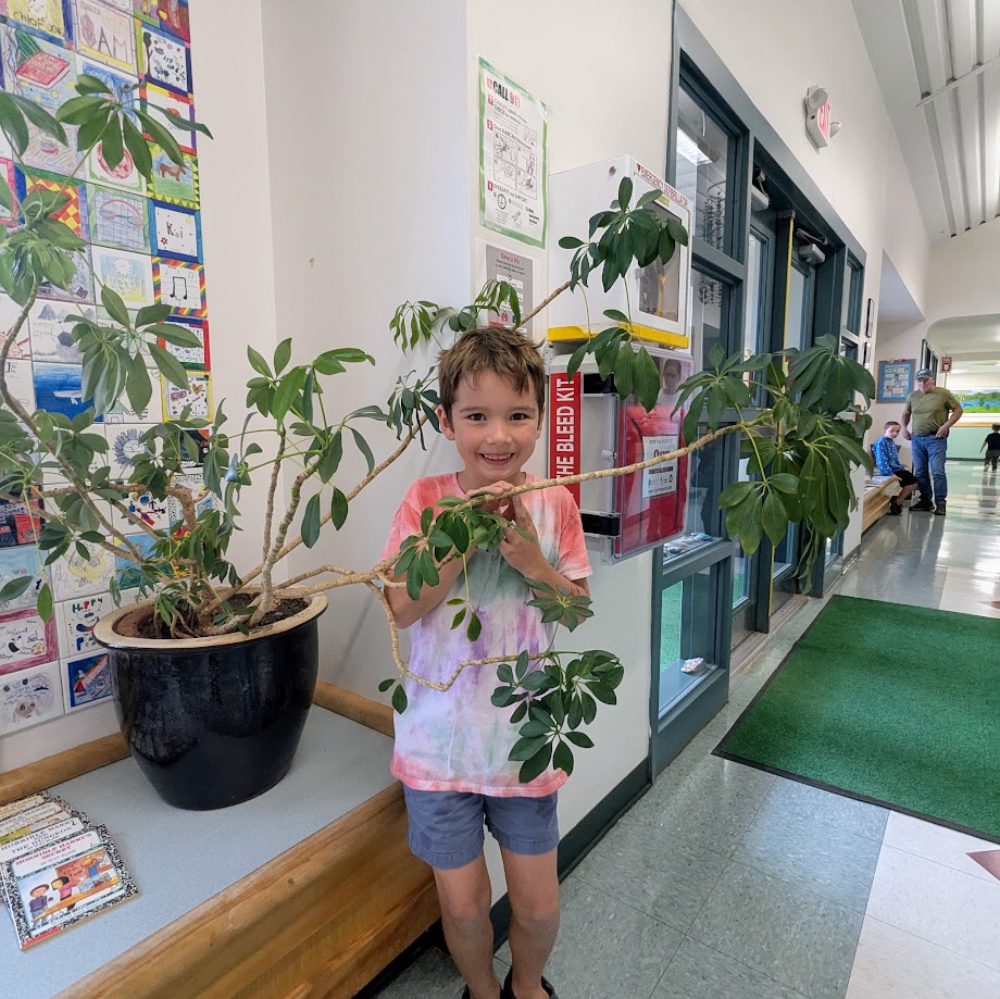 student behind plant